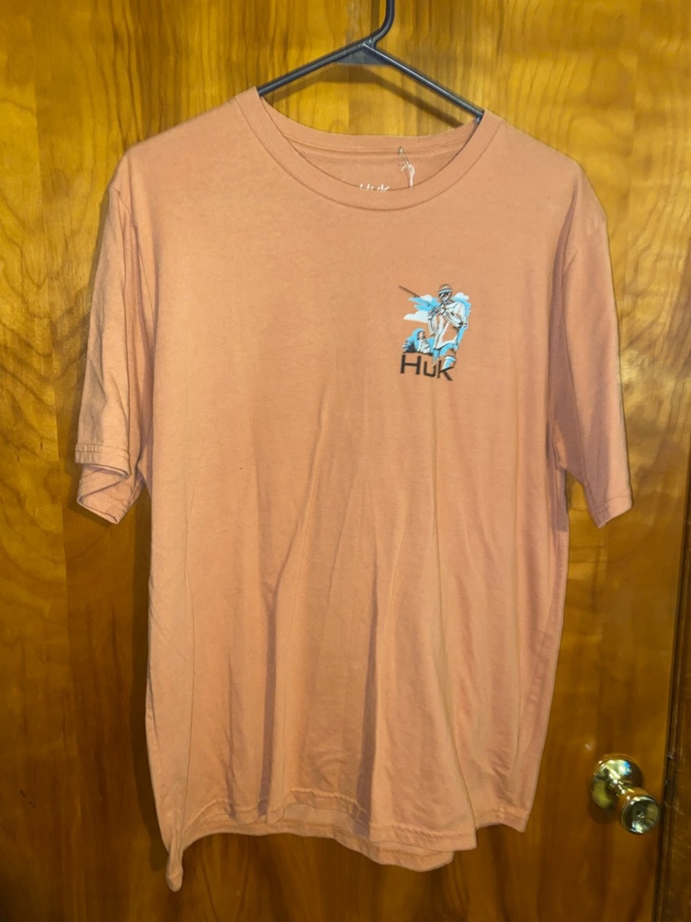 Huk Short-Sleeve Tee in Dusty Peach with Fishing Logo